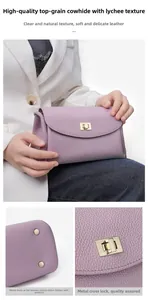 Detail of purple lychee grain leather handbag featuring metal clasp and protective bottom studs
