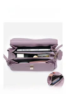 Detail view of purple lychee grain leather handbag with multi-layer pockets and gold lock