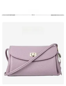 Detail of lavender purple genuine leather bag showing grain texture and metal twist lock