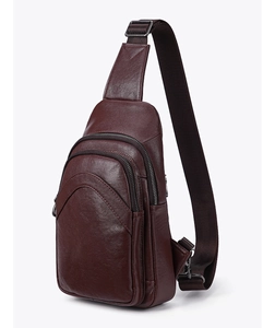 Detail view of deep brown leather sling bag with dual zippers and adjustable strap