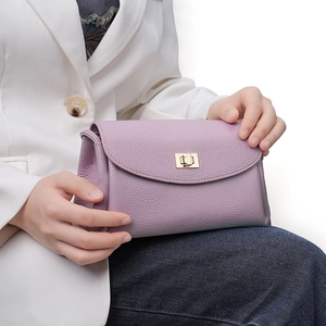 Lavender leather crossbody bag with lychee texture and gold-tone turn-lock closure