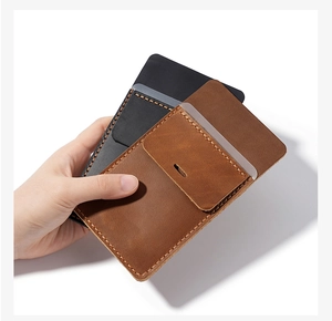 Detail of handcrafted brown and black leather pocket pen protectors with thick stitching