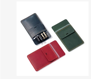 Detailed view of leather pocket protectors in navy, dark green, and wine red colors