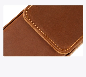 Macro detail of crazy horse leather pen case with yellow stitching and smooth texture