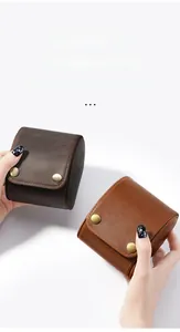 Macro detail of crazy horse leather watch pouches in dark brown and caramel tones