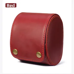 Close-up of red crazy horse leather single watch roll with vintage gold metal buckles