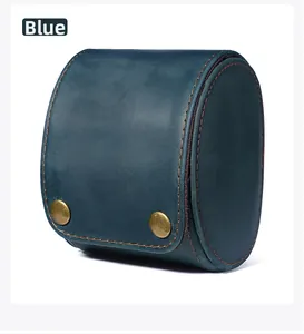 Macro detail of blue crazy horse leather watch roll with vintage metal snaps and stitching