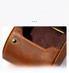 Macro shot of brown Crazy Horse leather watch box with vintage metal snap buttons