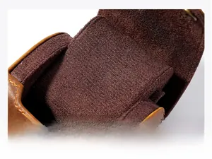 Macro detail of crazy horse leather watch box with soft velvet lining and neat stitching