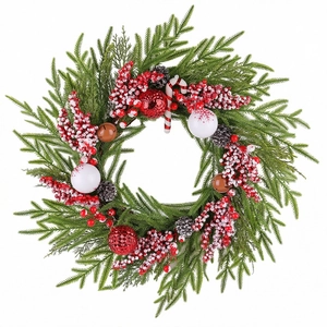 Weihnachtskranz mit Zapfen roten Beeren und Zuckerstange auf immergrünen Zweigen