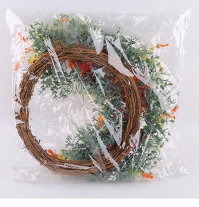 Detail of artificial rose wreath with eucalyptus leaves on vine base in polybag packaging