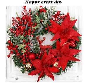 Detailed view of Christmas wreath featuring red poinsettias, berries, and glittery deer