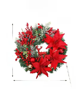 Detail of Christmas wreath with red poinsettia flowers, pine needles and a reindeer
