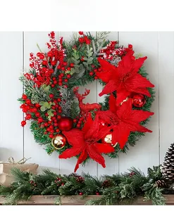 Detail of Christmas wreath with red deer, pine needles, and berries on white wood