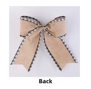 Detailed back view of burlap Christmas bow with black and white plaid ribbon edges