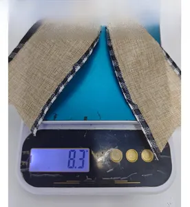 Close-up showing the 8.3g weight of a burlap Christmas ribbon bow on a digital scale