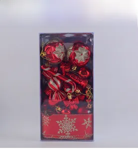 Detail of red Christmas ball ornaments and candy canes with gold snowflakes in a clear box