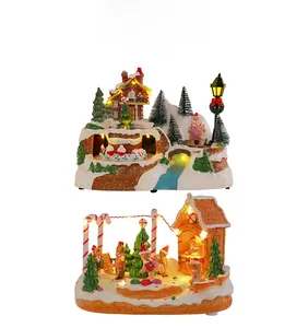 Detail of light-up Christmas music box with rotating train and gingerbread house scene