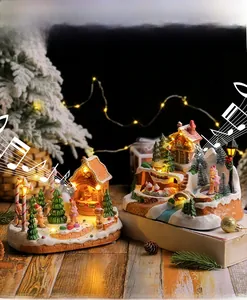 Detail of Christmas music boxes with LED lights featuring gingerbread house and snowy town scenes