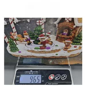 Detailed view of the Christmas gingerbread train music box weighing 965g on a scale