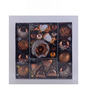 Detailed set of bronze and brown Christmas ornaments with varied textures in a clear box