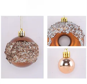 Detail of Christmas donut ornaments and shimmering glitter balls with gold hanging strings