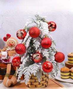 Close-up of red Christmas ball ornaments with painted stars and stripes on a tree