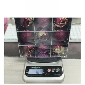 Weight measurement of 9-pack burgundy Christmas ornaments in a transparent box