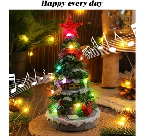 Close-up of LED glowing Christmas tree music box with miniature houses and snowy texture
