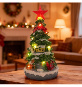Macro shot of glowing Christmas tree music box with LED lights and miniature houses