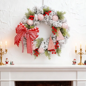 Christmas wreath with flocked pine needles red berries and red-white checkered bow decor