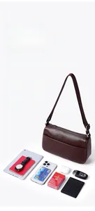 Detailed top view of a brown leather messenger bag with multiple storage compartments