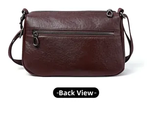 Detail view of the back zipper pocket on a brown leather crossbody bag with pebble grain