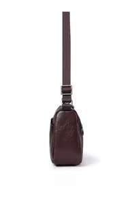 Side view of dark brown pebbled leather crossbody bag with adjustable textile strap