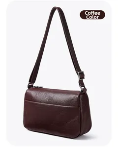Macro shot of natural texture leather on coffee brown shoulder bag with silver hardware