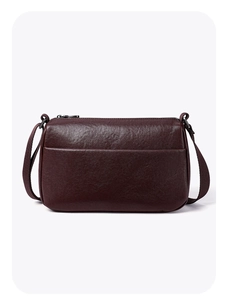 Detailed view of dark brown leather crossbody bag featuring fine grain texture and zipper