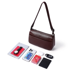 Dark brown leather crossbody bag shown with tablet and gadgets for capacity display