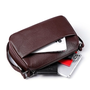 Brown leather crossbody bag showing internal storage for tablet, phone, and wallet