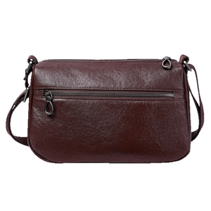 Classic burgundy pebbled leather crossbody bag with adjustable strap on white background