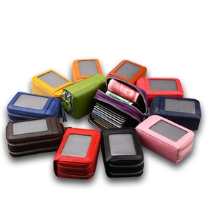 Detailed view of colorful leather card holders with dual zippers and accordion slots