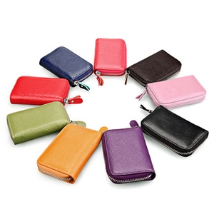 Macro shot of colorful leather card holders in various shades with lychee texture and zippers
