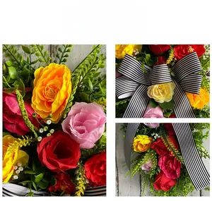 Detail view of artificial rose wreath with striped ribbon bow and lush greenery