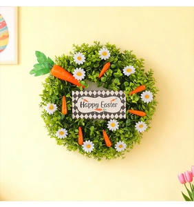 Detail eines Osterkranzes mit Gänseblümchen und Karotten an einem festlichen Türhänger