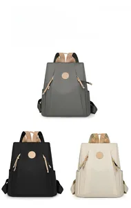 Three lightweight nylon backpacks displayed in grey, black, and beige colors