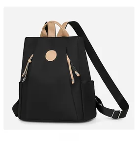 Side view of waterproof nylon backpack with leather handles and round logo detail