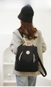 Rear view of model wearing a black anti-theft nylon backpack for stylish daily commute