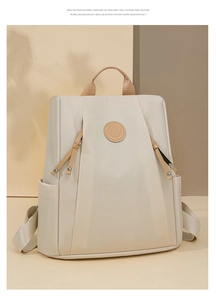 Detailed view of the nylon backpack with sunflower patch and stylish leather zipper puller