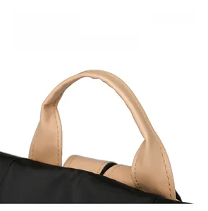 Detail display of the comfortable round leather handle and durable nylon stitching on bag