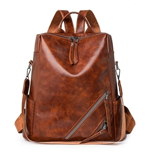 Brown vintage leather backpack with checkered texture and adjustable straps for women