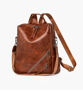 Detail view of checkerboard backpack showing brown vintage texture and side pockets